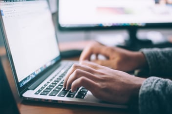 A quality website. Man typing on a laptop keyboard